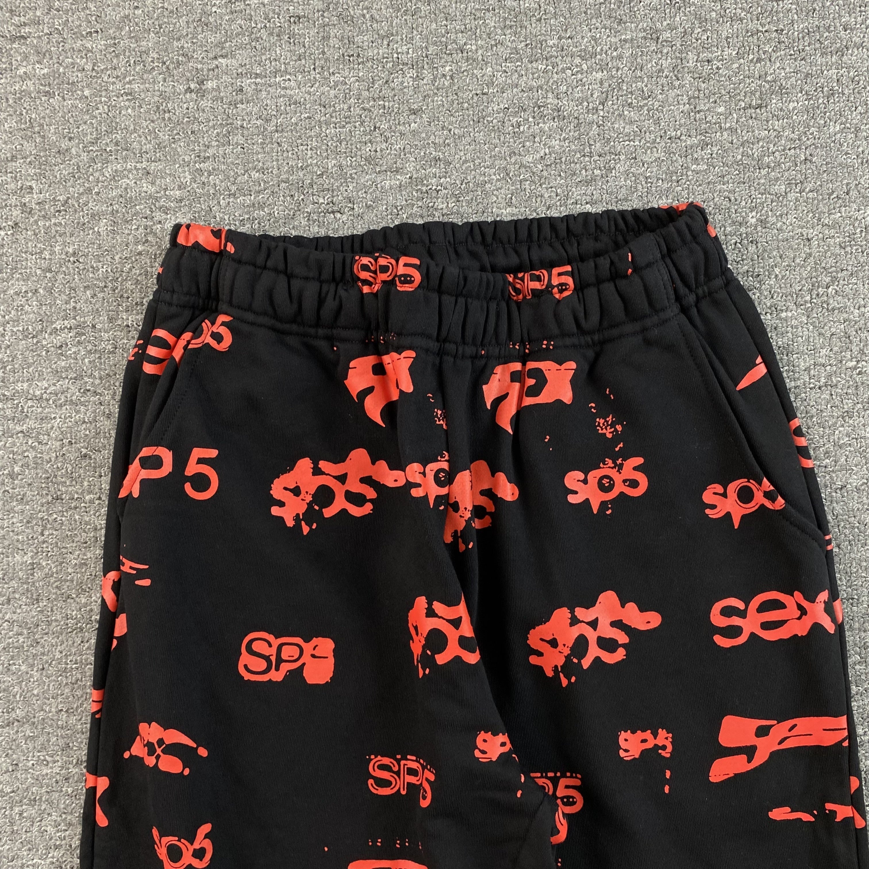 SP5DER SEX AOP SWEATPANTS BLACK